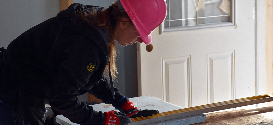 A GNI worker cuts rigid insulation